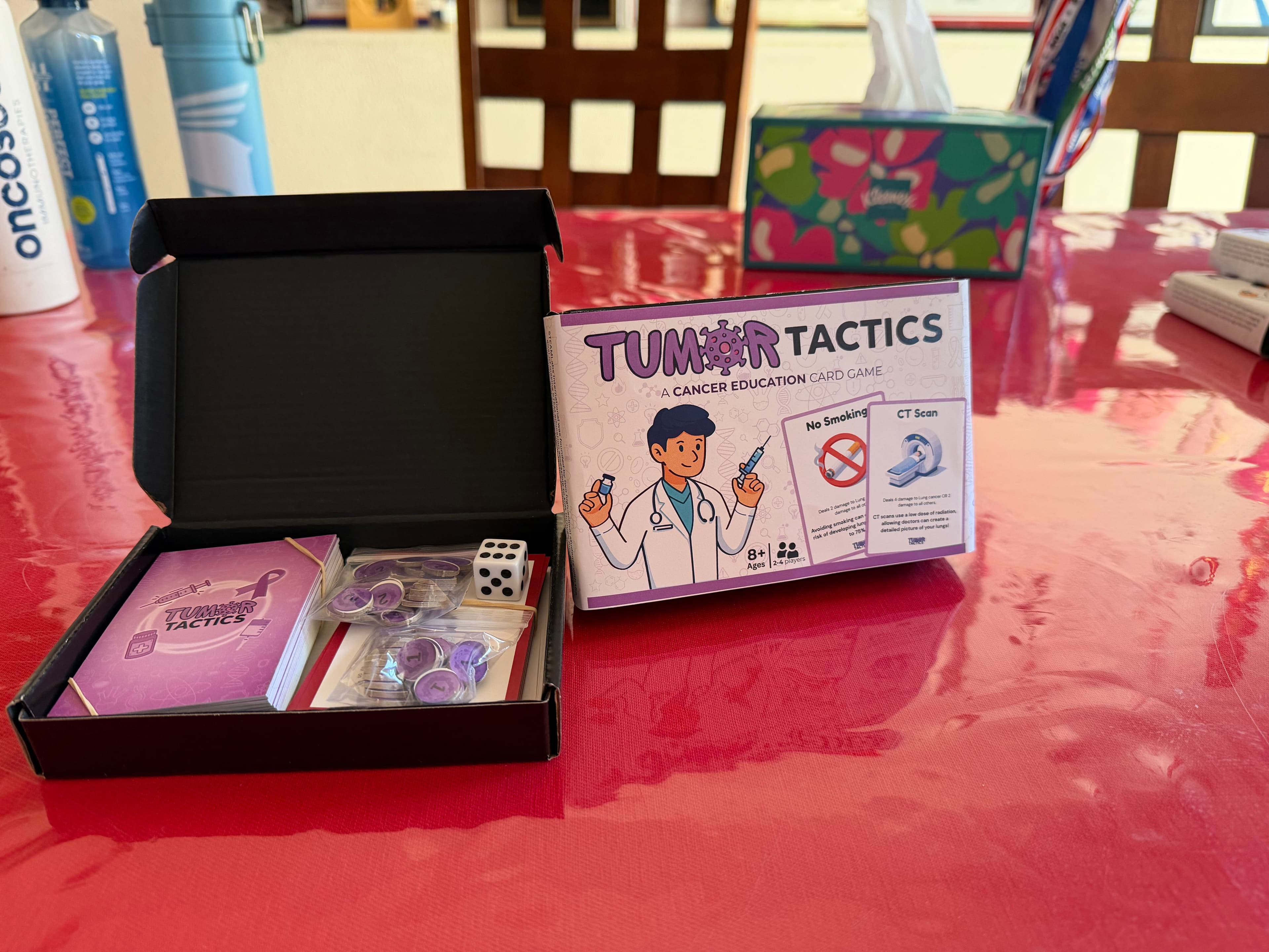 Tumor Tactics game components laid out on a table